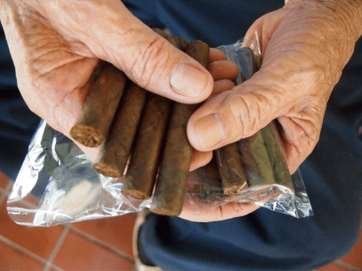 My grandfather holding out his packet of cigars